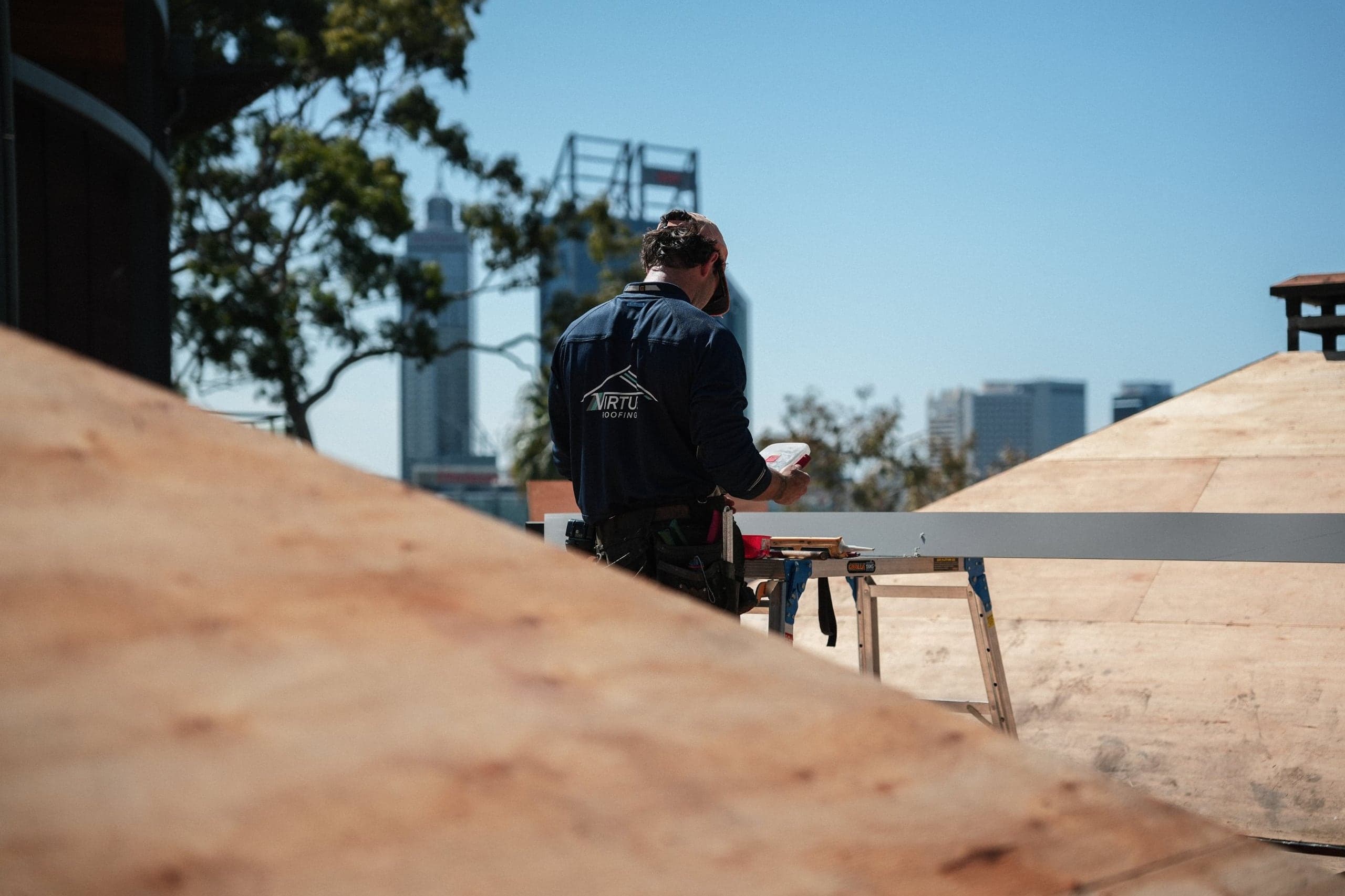 Virtue roofer on a Kings Park roof with the Perth city skyline behind