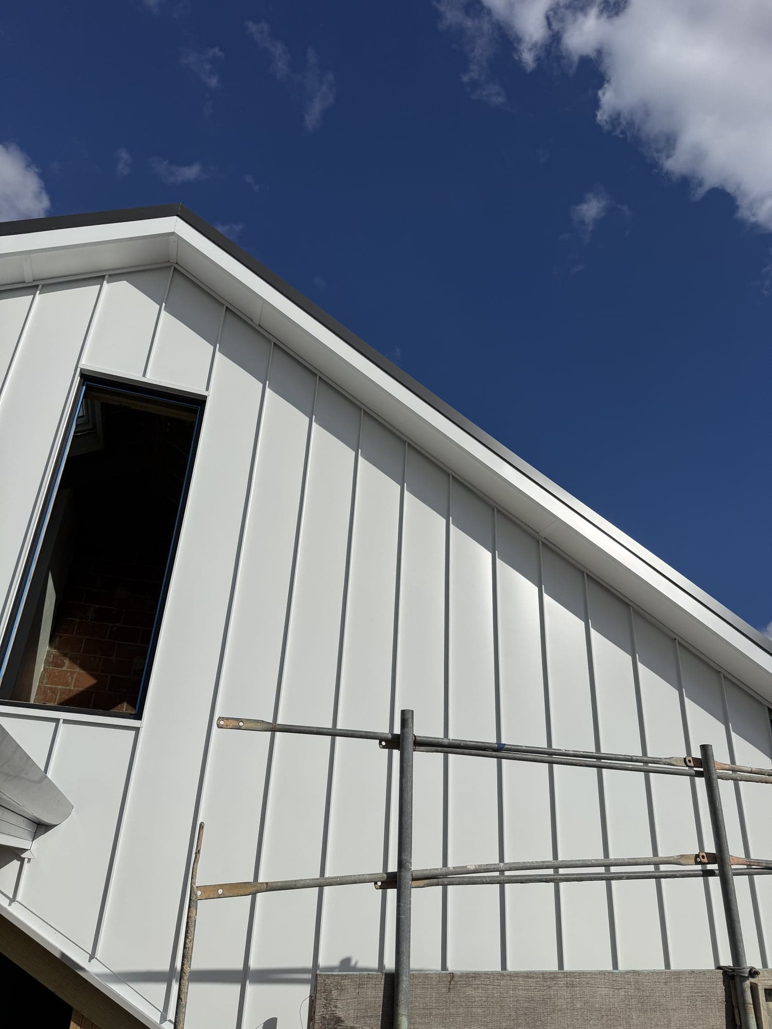 Dover White Colorbond standing seam going onto a gable in Ascot, Perth