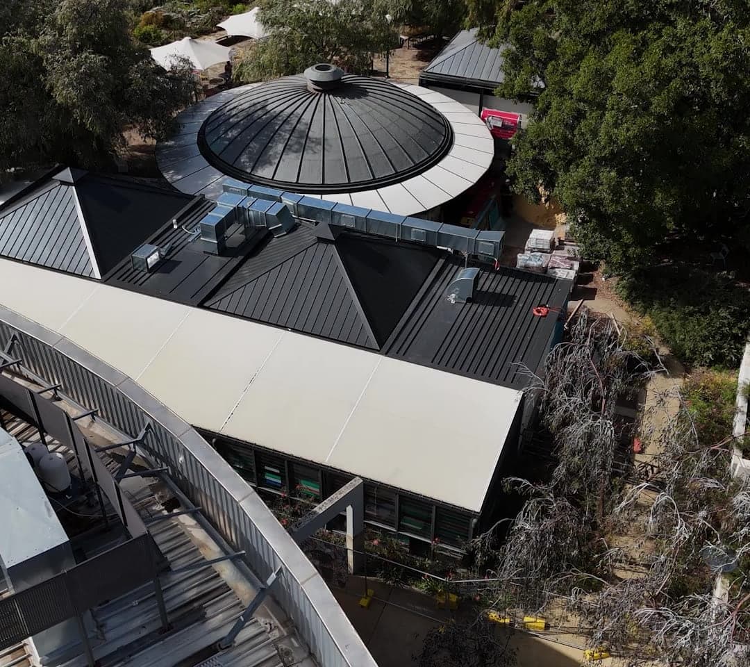 Aerial view of the dark metal roofs and dome Virtue Roofing re-roofed in Kings Park, Perth