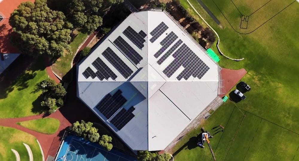 Top-down view of the Prendiville College hall metal roof with solar panels, Perth