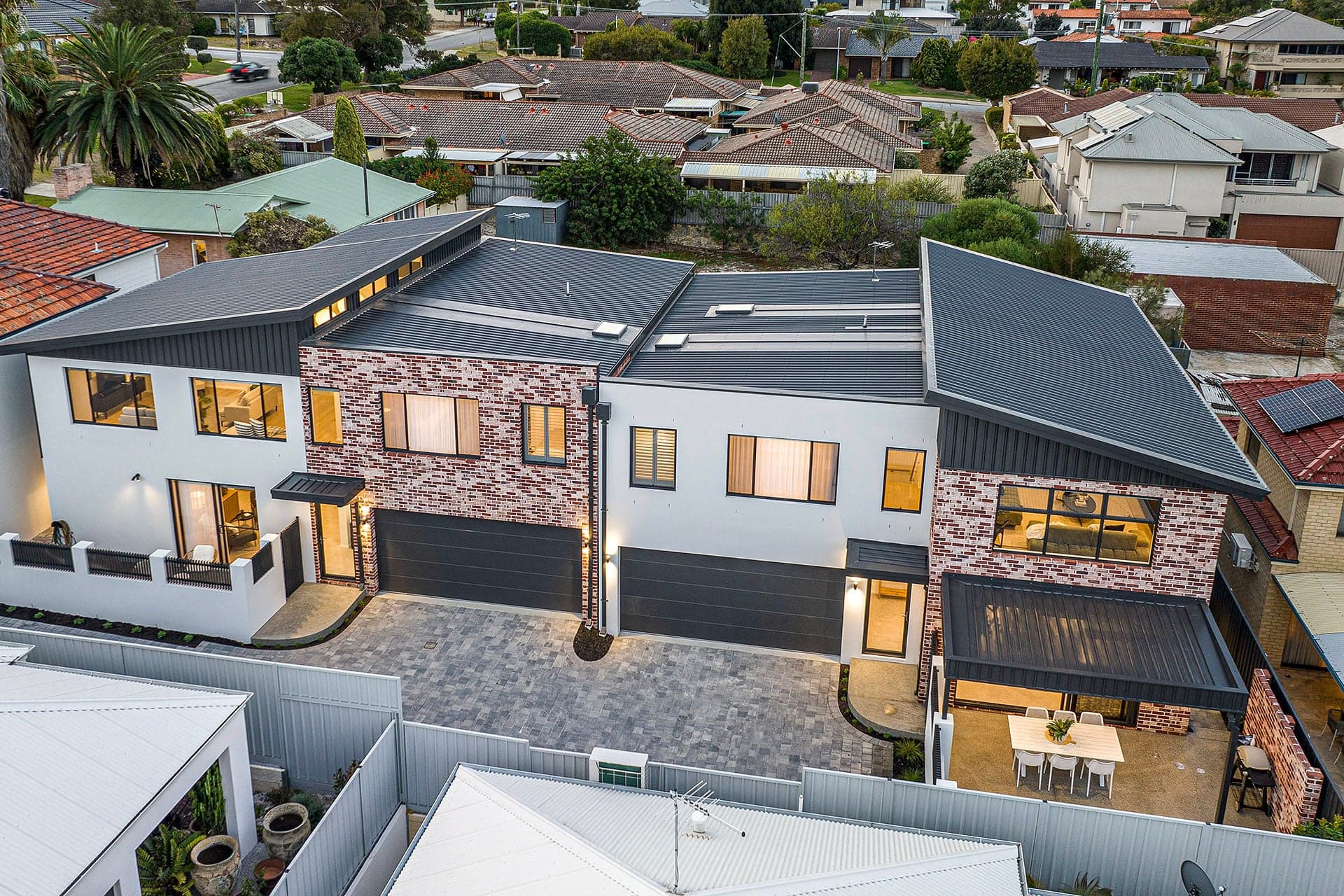 Aerial view of metal roofs on a row of new brick townhouses in Yokine, Perth