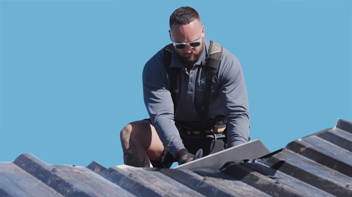 A person doing residential metal roofing