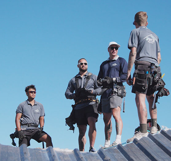 Workers working on metal roof installation